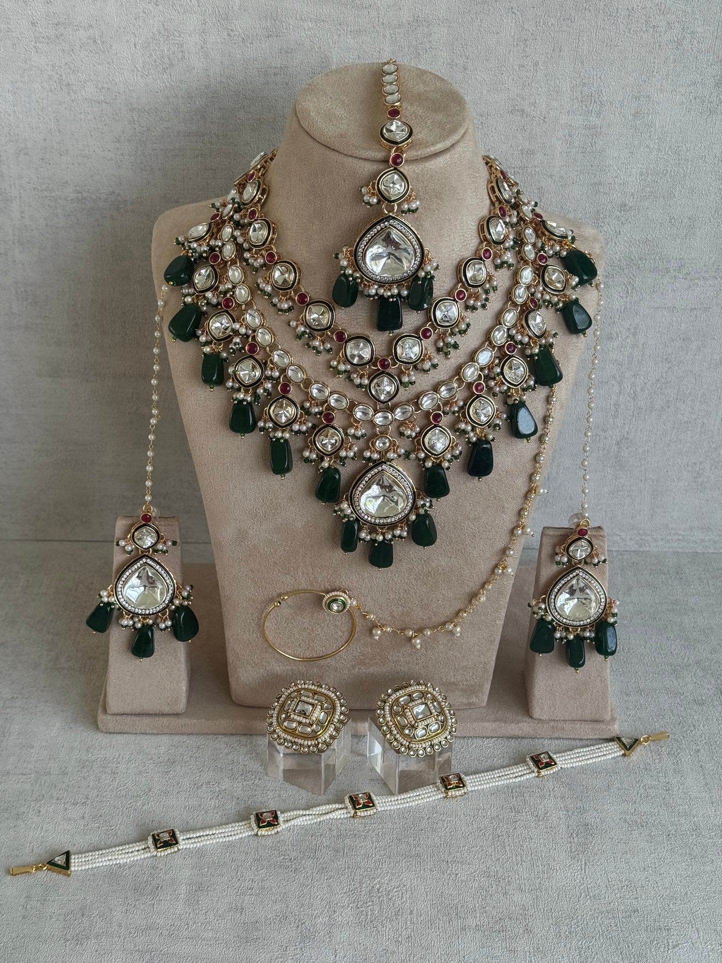 Ayura Designs Malika Bridal Set with Necklace, Jhumkis, Tikka, Nath, Ring & Sheeshphool – Jadau Kundan Craftsmanship with Mirror-Cut Polki, Emerald Green Drops, Ruby Accents & Antique Gold Finish