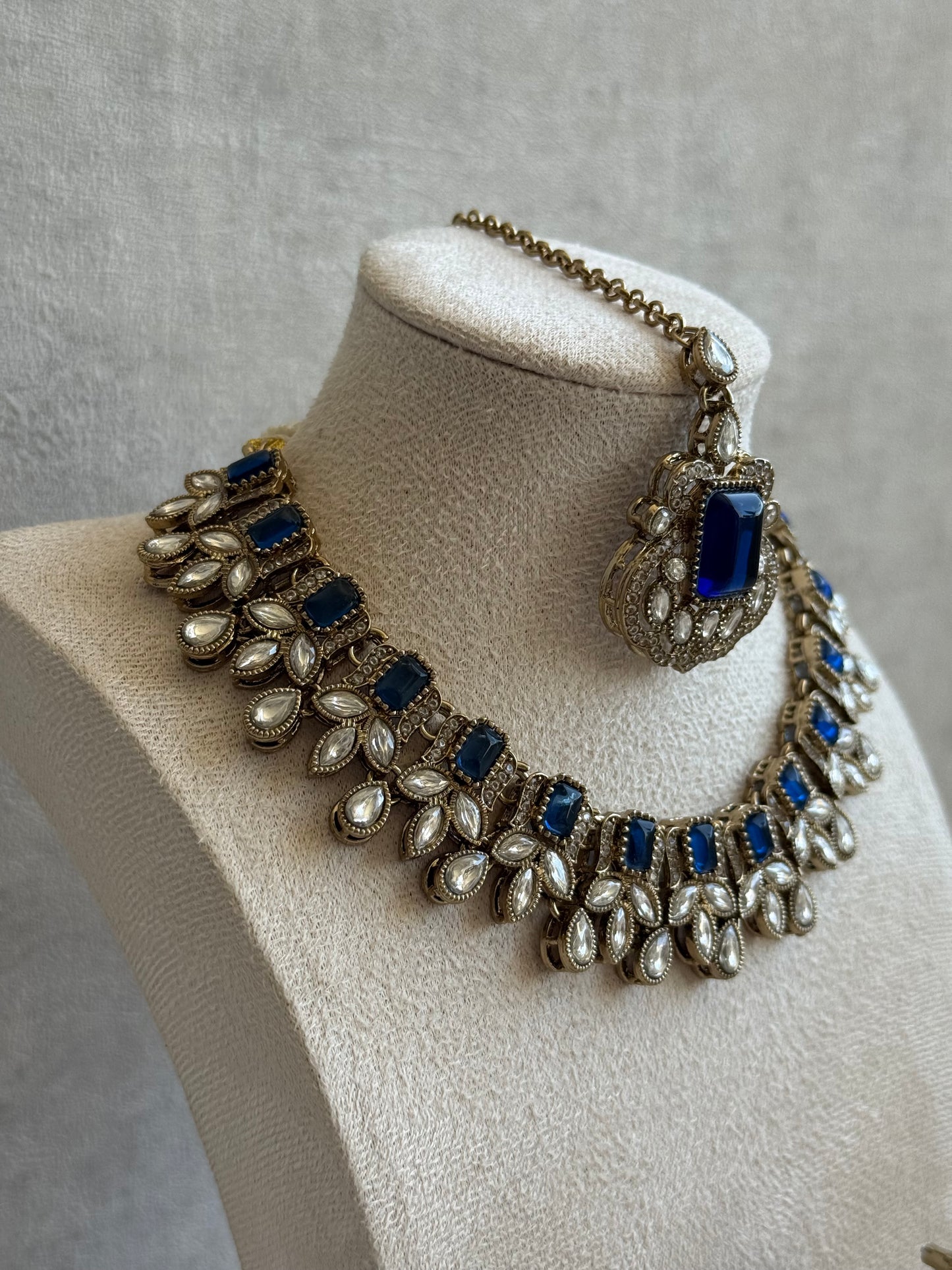 Ayura Designs Olivia Set with Necklace, Earrings & Tikka – Navy Blue Stones, Pear-Cut White Accents & Antique Gold Finish
