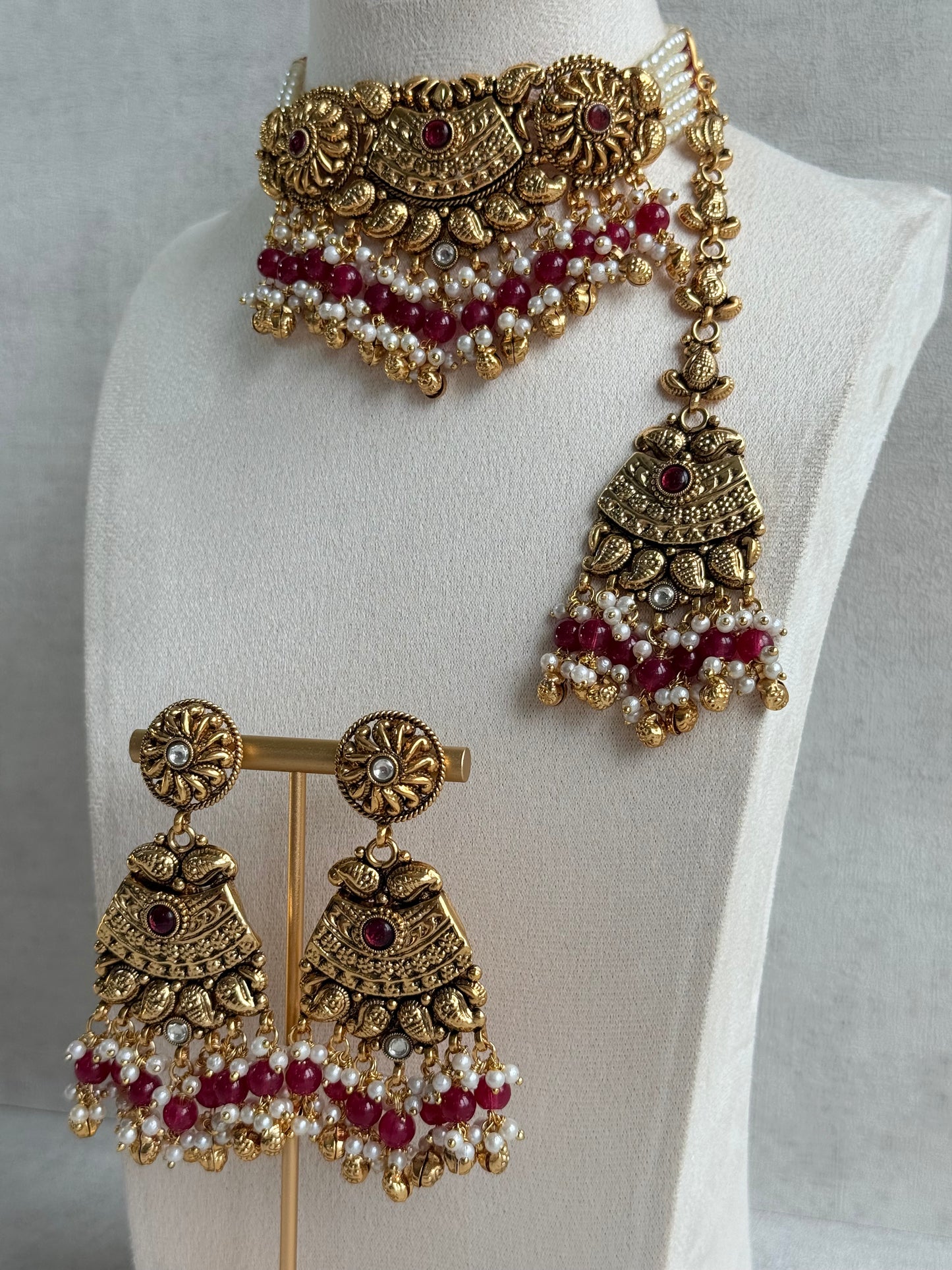 Ayura Designs Sairish Choker Set with Earrings & Tikka – Ruby Pink Beads, Pearl Detailing, Ghungroos, Paisley Motifs & Antique Gold Finish