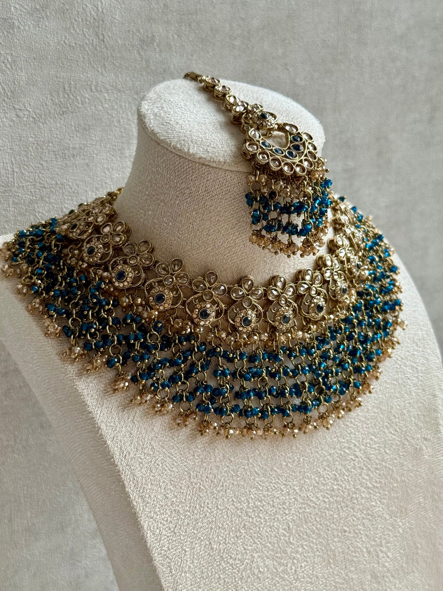 Ayura Designs Mahreen Set – Necklace, Jhumkis & Tikka with Mirror-Cut Stones, Peacock Blue Beads & Gold Finish