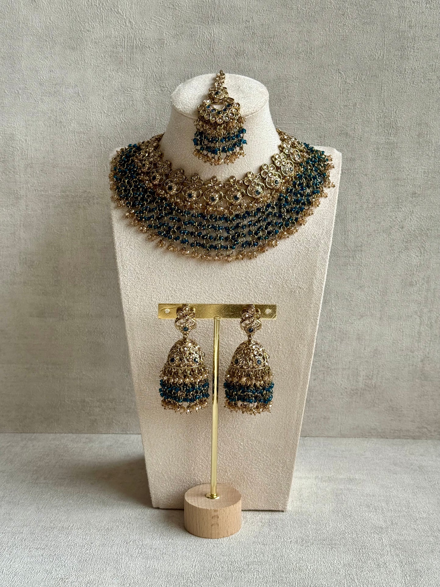 Ayura Designs Mahreen Set – Necklace, Jhumkis & Tikka with Mirror-Cut Stones, Peacock Blue Beads & Gold Finish