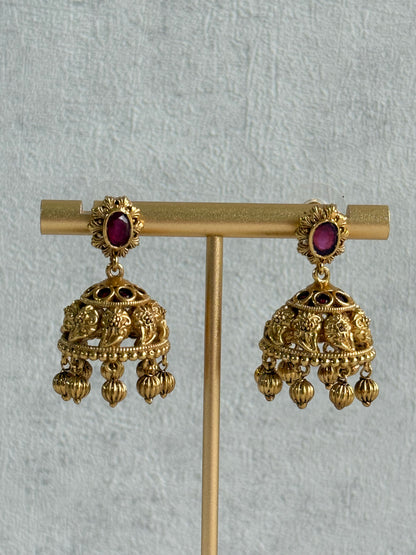 Ayura Designs Savya Jhumkis – Rani Pink Stones, Floral Motifs & Antique Gold Finish