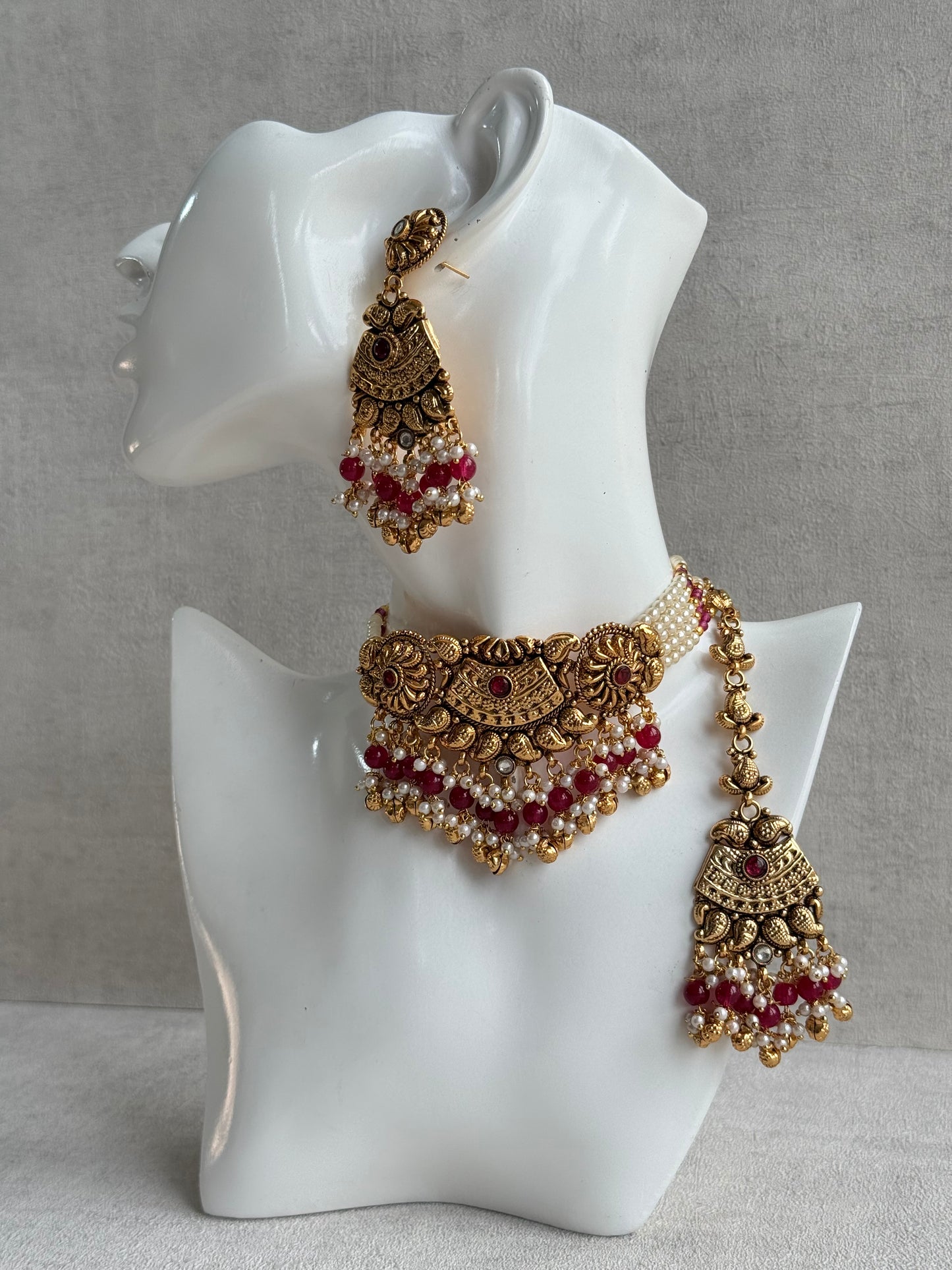 Ayura Designs Sairish Choker Set with Earrings & Tikka – Ruby Pink Beads, Pearl Detailing, Ghungroos, Paisley Motifs & Antique Gold Finish