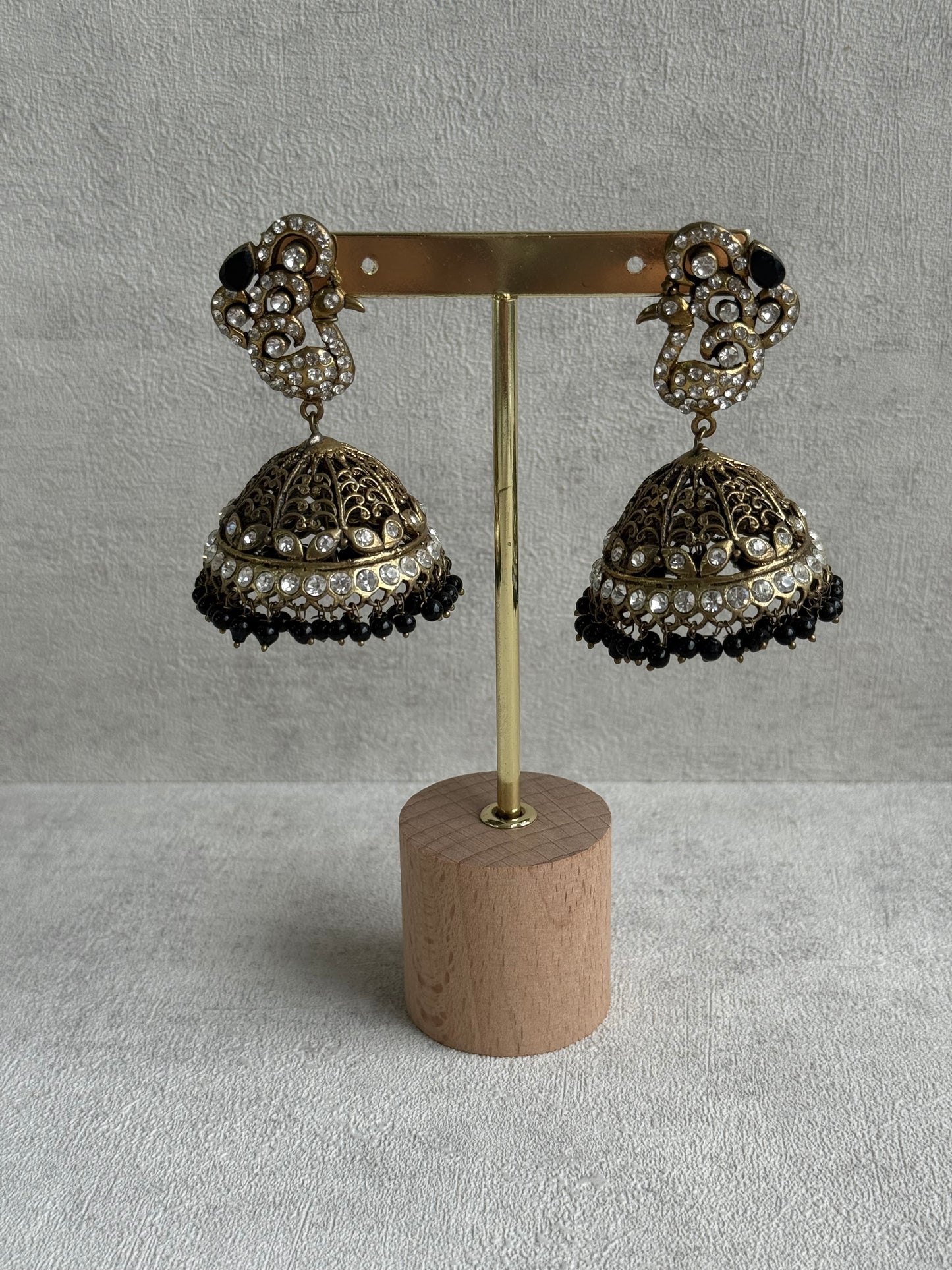 Ayura Designs Mayurika Jhumkis – Antique Gold Jhumkis with Crystal Stones, Black Beads & Peacock Motif