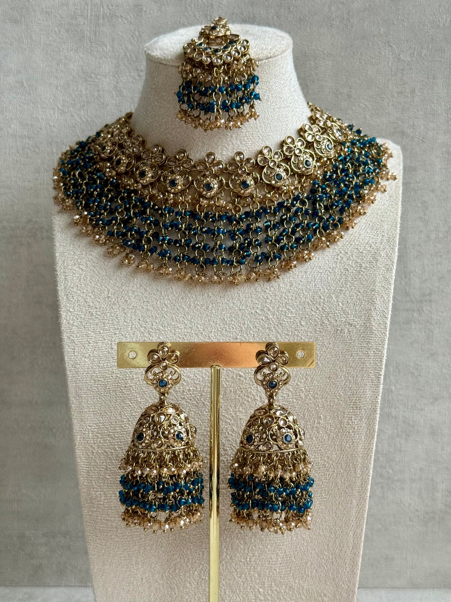 Ayura Designs Mahreen Set – Necklace, Jhumkis & Tikka with Mirror-Cut Stones, Peacock Blue Beads & Gold Finish