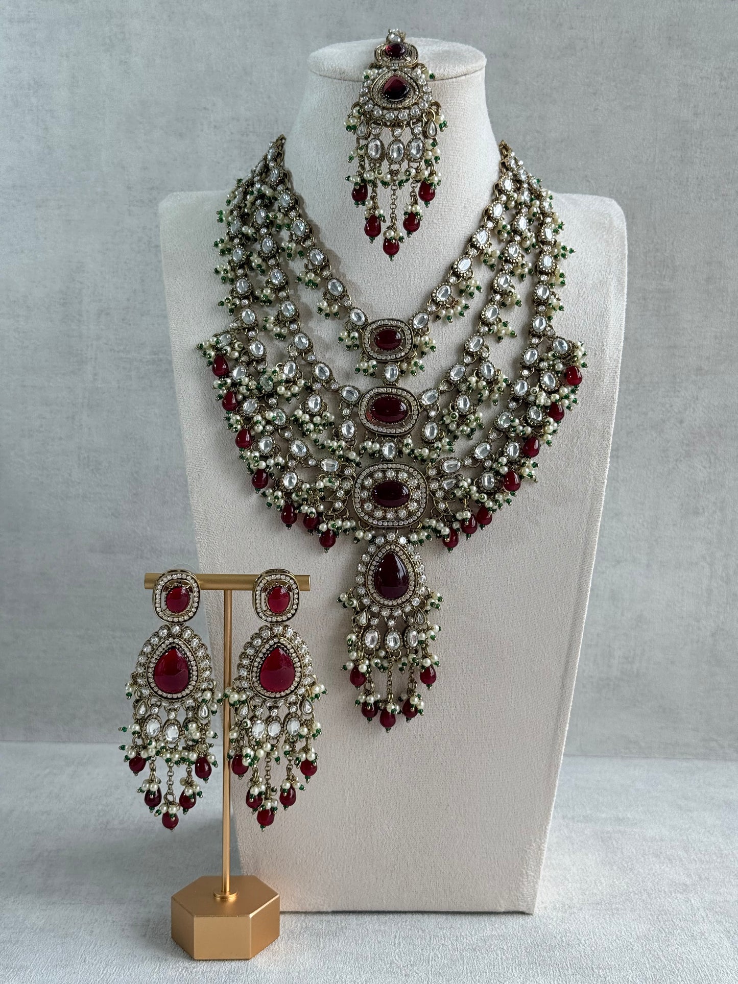 Ayura Designs Sahra Bridal Set with Earrings & Tikka – Ruby Red, Kundan Stones, Pearls & Emerald Green Accents in Antique Gold Finish