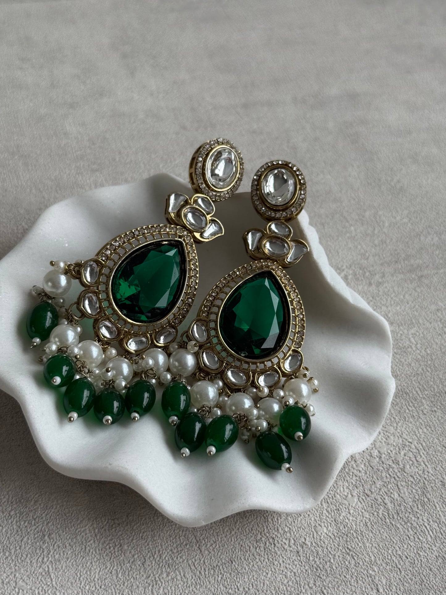 Ayura Designs Nageen Earrings – Antique Gold Jhumkis with Emerald Green Stones, Mirror-Cut Accents & Pearl Drops