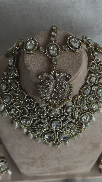 Ayura Designs Tajdar Bridal Set with Necklace, Jhumkis, Tikka, Nath, Ring & Sheeshphool – Jadau Kundan Craftsmanship with Mirror-Cut Polki, Ivory Pearl Drops & Antique Silver-Gold Finish