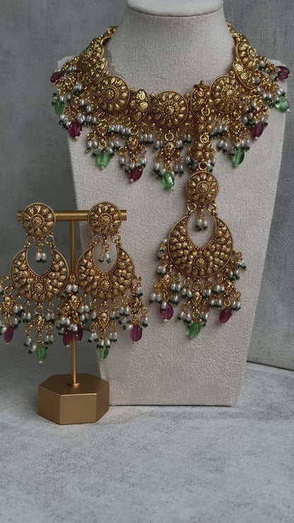 Ayura Designs Rummy Set – Opulent Gold Adornment with Radiant Pink, Green & White Beads | Includes Earrings & Tikka